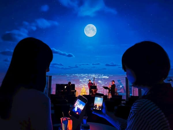 Invitados disfrutando de bebidas mientras ven el espectáculo del planetario