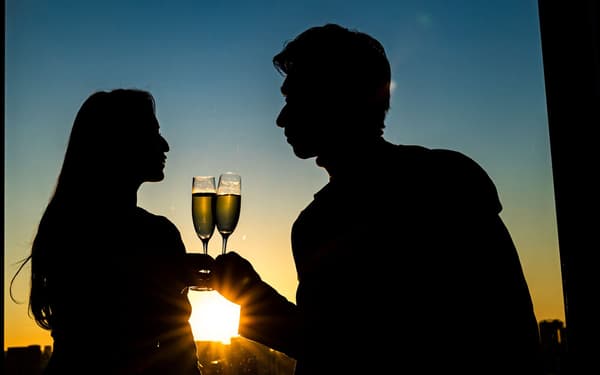Couple with bouquet at romantic dinner