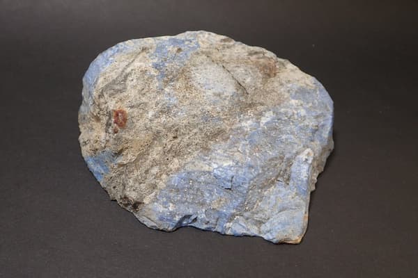 Lapis lazuli from Itoigawa. The surface shows a dull, grayish-blue color due to weathering.