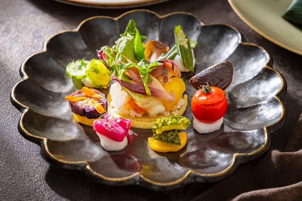 Appetizer: a colorful seasonal vegetable palette in garden-inspired presentation