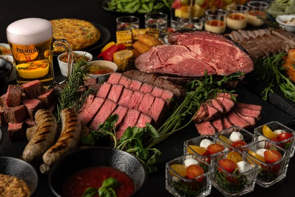 Beef steak, pork steak, and herb sausages prepared in teppan style