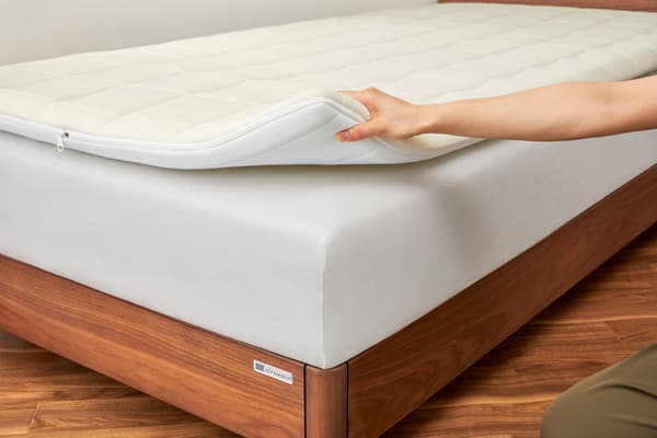 Mattress pad provides support and breathability when placed on bed mattress
