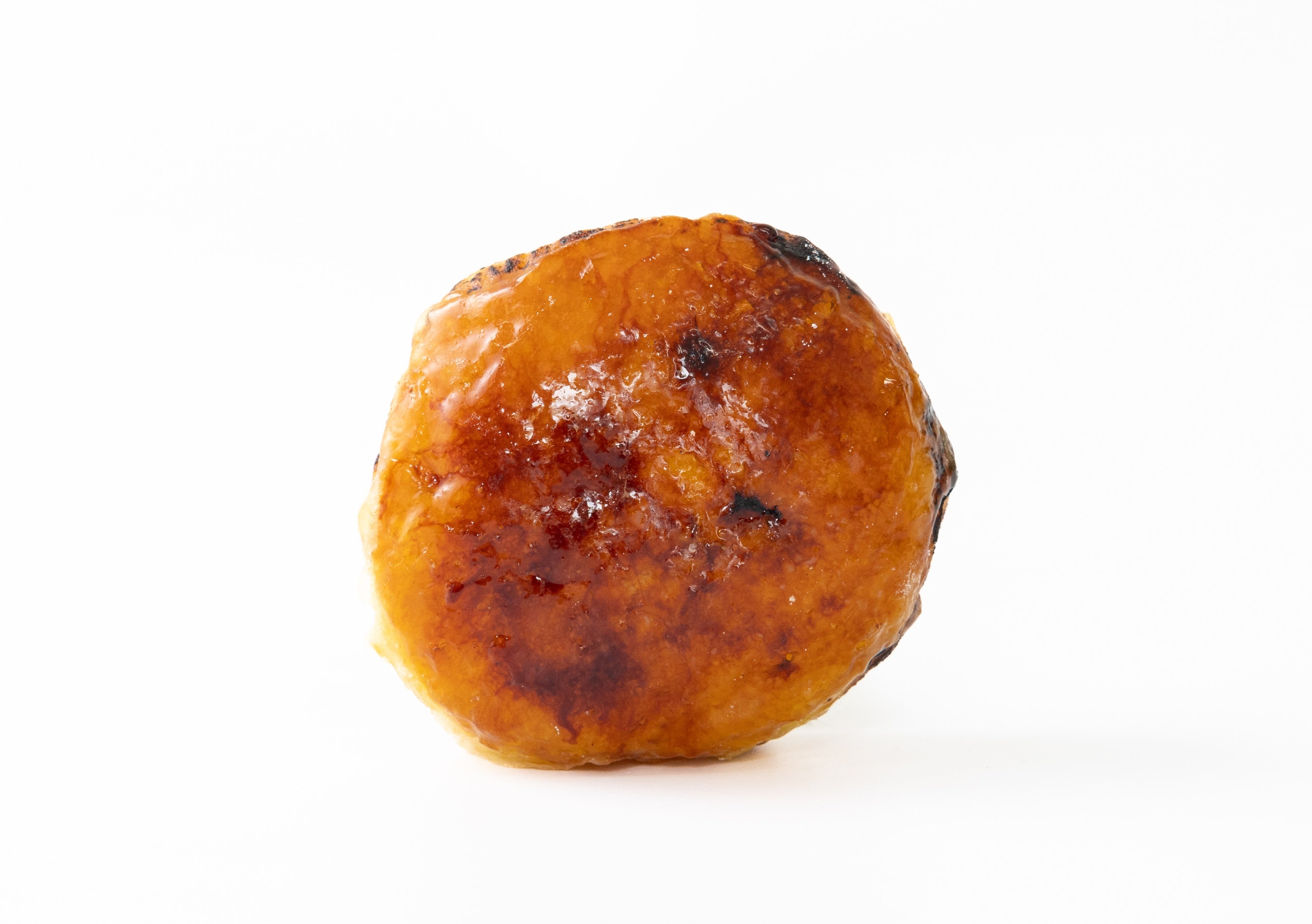 Nama Malasada Cream Brulee - 352 yen: Fluffy, melt-in-your-mouth light malasada dough made with pumpkin and sweet potato, caramelized to a crisp on the surface. Inside, egg-rich custard creates a sweet and bittersweet adult brulee donut.