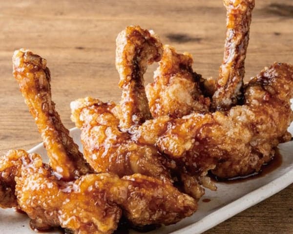 Juicy fried chicken wings coated in sweet and savory sauce