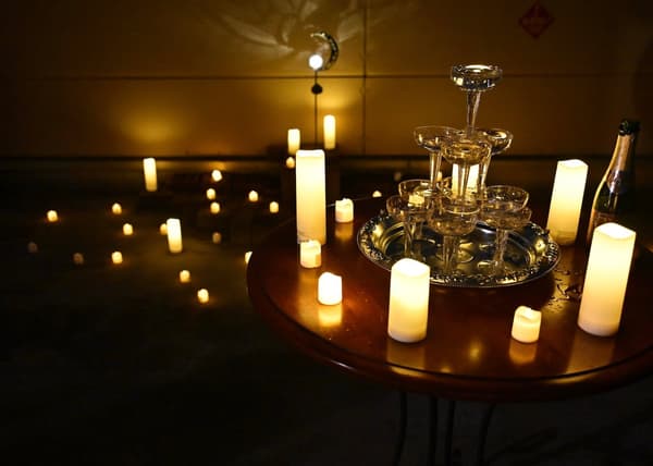 Champagne tower with candle and light decorations on the rooftop