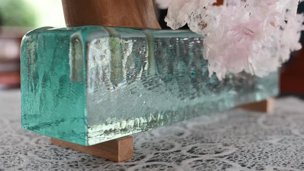 Blue glass panels made from recycled fluorescent lamps, glowing with filtered light