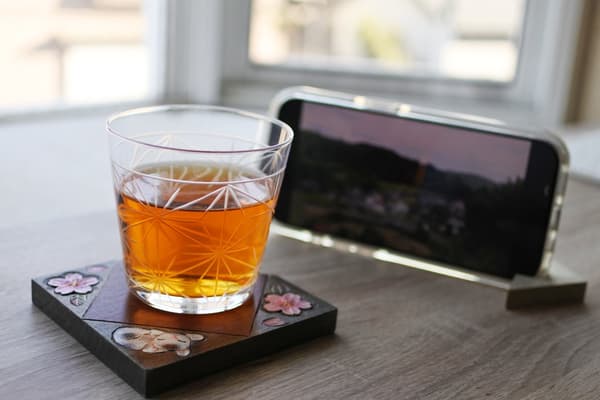 Nikko in - Smartphone Stand and Coaster in Use