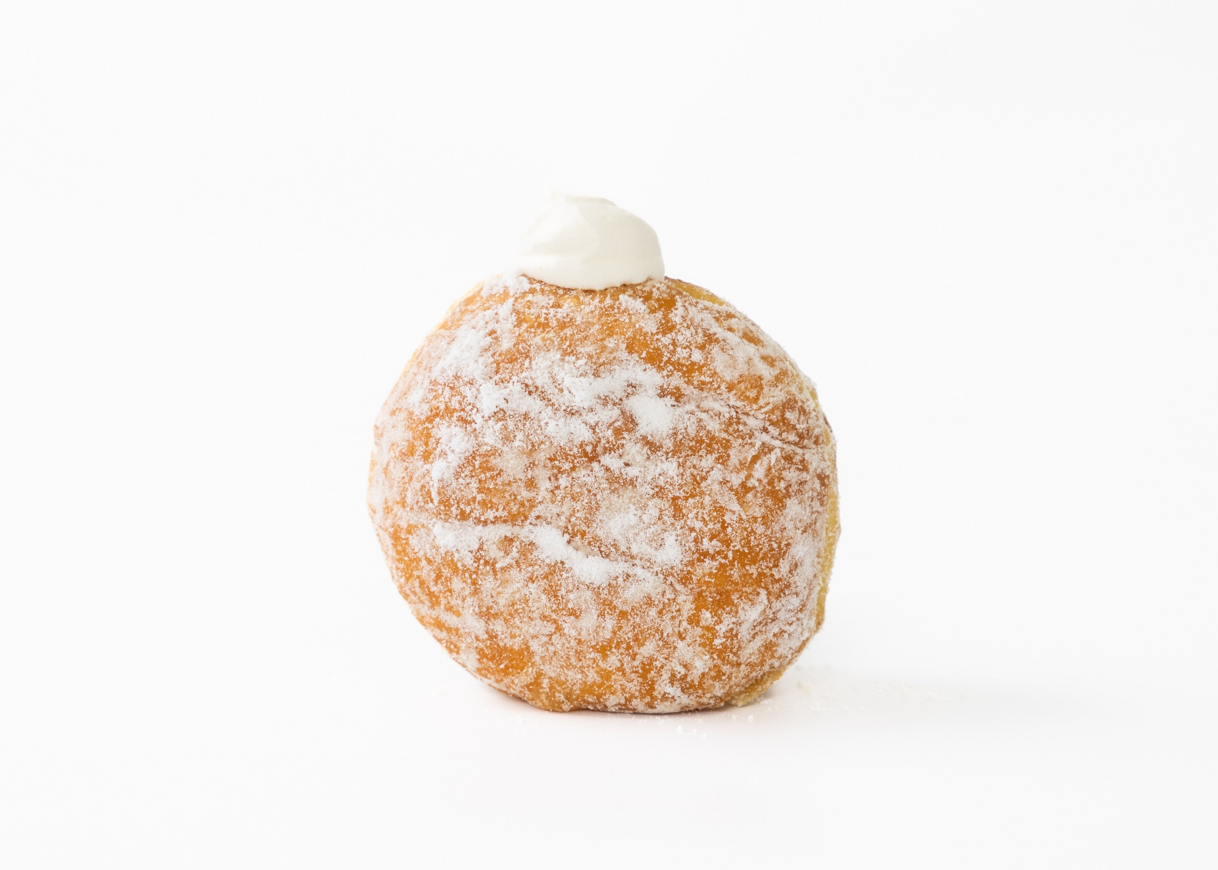 Nama Malasada Condensed Milk - 330 yen: Nama malasada dough filled with rich, creamy condensed milk whipped cream. The milky whipped cream mixed with condensed milk pairs perfectly with the gentle dough.
