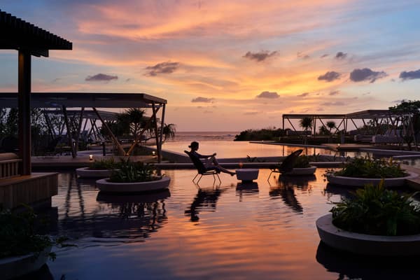 The infinity pool reflecting the shifting colors of the sky