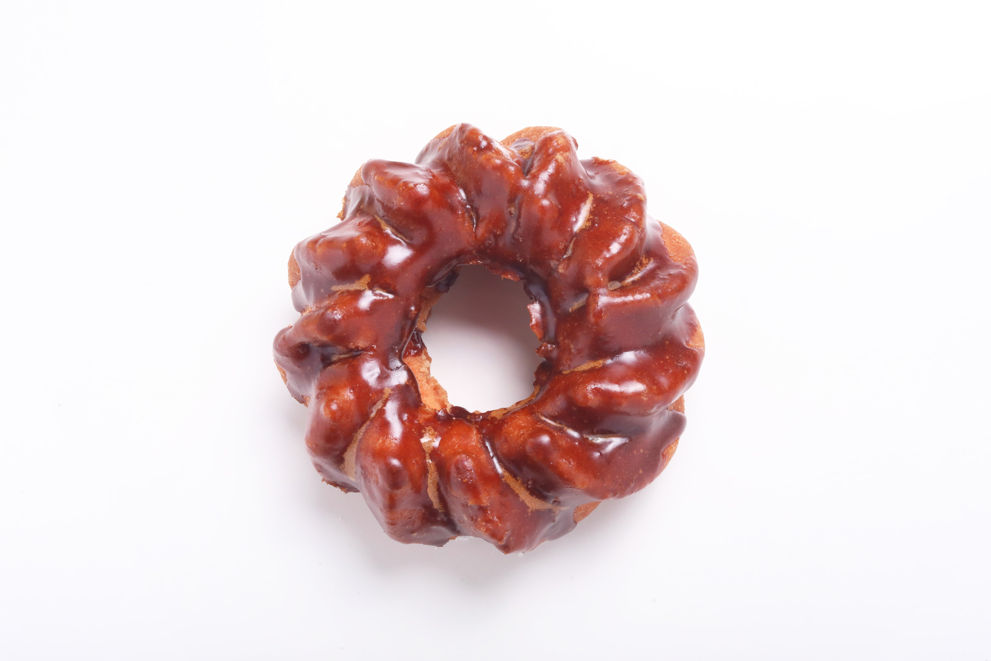 Canele Donut - 264 yen: A donut finished more authentically with the characteristic chewy texture of French confection canele, bitter caramel glaze, and added rum flavor.