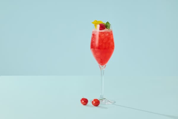 Welcome mocktail with cherry and viola flower