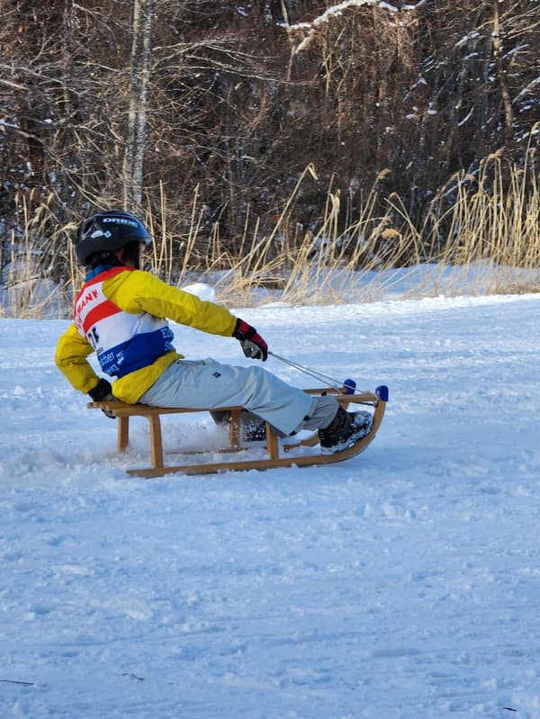 Snow luge participants enjoying the sport
