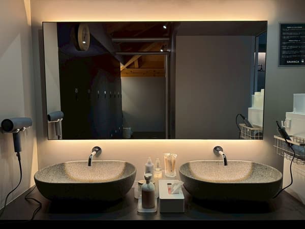 Spacious powder room with four SALONIA hair dryers