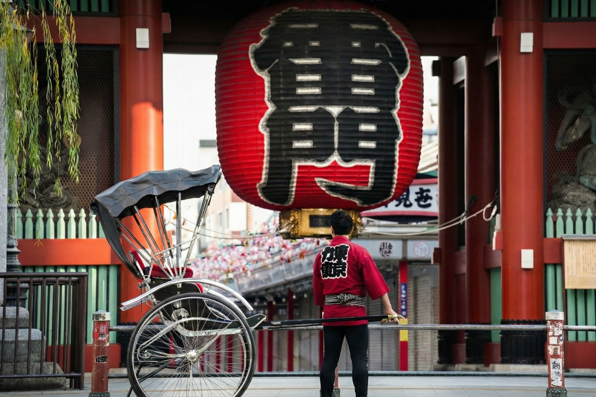 Tokyo Rickshaw pullers standing with rickshaw in front of Kaminarimon